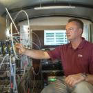 frank mitloehner sitting in emissions sampling trailer surrounded by machines